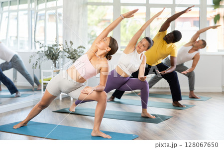 Girl doing Extended Side Angle Pose at yoga training 128067650