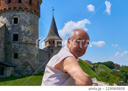 Elderly male pensioner on tour in the old town Elderly male pensioner on tour in the old town 128068608