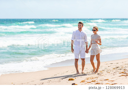 Adorable girl and happy dad having fun during beach vacation 128069913