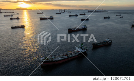 Aerial view oil tanker ship and gas tanker ship at sunset, Silhouette oil and gas tanker ship at oil and gas terminal, Global business import export logistic transportation oil and gas petroleum. 128071701