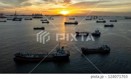 Aerial view oil tanker ship and gas tanker ship at sunset, Silhouette oil and gas tanker ship at oil and gas terminal, Global business import export logistic transportation oil and gas. Aerial view oil tanker ship and gas tanker ship at sunset, Silhouette oil and gas tanker ship at oil and gas terminal, Global business import export logistic transportation oil and gas. 128071703