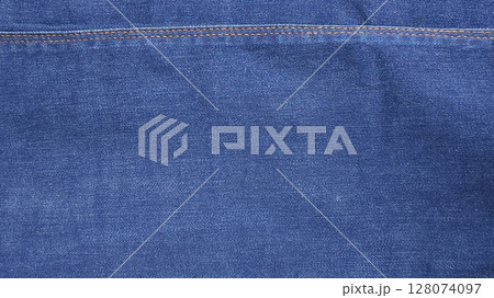 Close-up of blue denim jeans fabric texture background Close-up of blue denim jeans fabric texture background 128074097