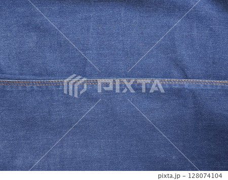 Close-up of blue denim jeans fabric texture background Close-up of blue denim jeans fabric texture background 128074104