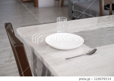 Serving a plate on the table at home Serving a plate on the table at home 128076514