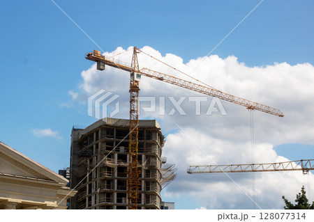 A structure under construction features a crane in the foreground 128077314