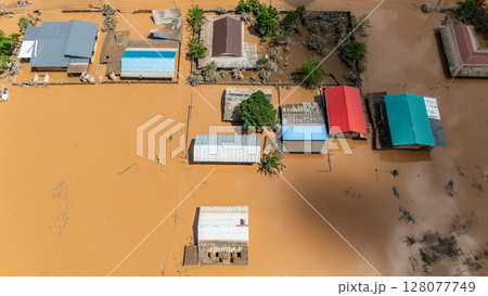 Aerial view of small village in suburb of Chiang Rai flooding by Kok river after typhoon Yagi has swept Southeast Asia. 128077749