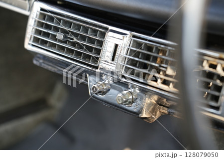 Classic car air vents are captured in close up, focusing on their structure and function, proving the system still works effectively and looks visually clean. 128079050