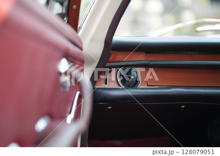 Classic car air vents are captured in close up, focusing on their structure and function, proving the system still works effectively and looks visually clean. 128079051