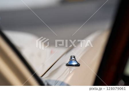 a vintage car manual door lock knob, reflecting design simplicity from a mechanical era. This small component played a key role in car security before electronic systems. a vintage car manual door lock knob, reflecting design simplicity from a mechanical era. This small component played a key role in car security before electronic systems. 128079061