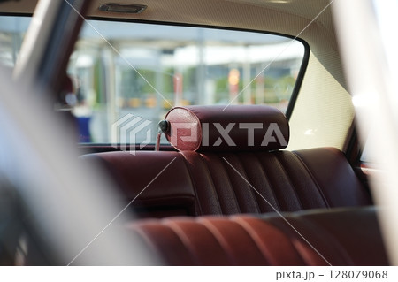 Leather rear seats of a vintage classic car mid-20th century automotive craftsmanship, with textured surfaces, comfort and retro aesthetics. 128079068