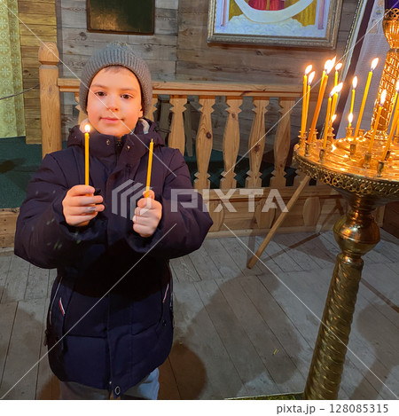 A boy in church lights candles. The Concept of the Religion of Christianity. 128085315