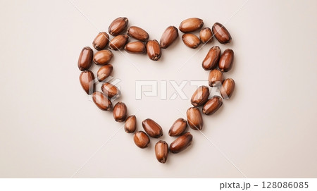 Jojoba nut arranged in the shape of a heart copy space black white background 128086085