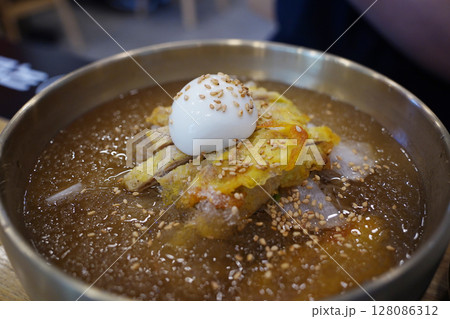 Close-up of Korean Naengmyeon Cold Noodles Topped with Sliced Beef Pancake (Yukjeon) 128086312