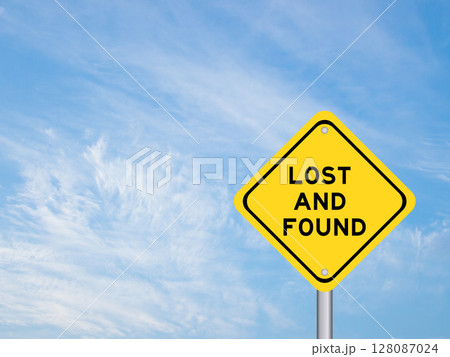 Yellow transportation sign with word lost and found on blue color sky background 128087024