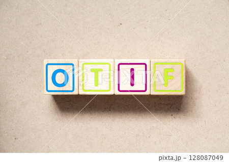 Alphabet letter block in word OTIF (abbreviation of On Time In Full) on wood background Alphabet letter block in word OTIF (abbreviation of On Time In Full) on wood background 128087049