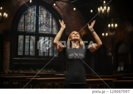 Radiant young woman jubilantly raising her arms to the sky in an atmospheric vintage house Radiant young woman jubilantly raising her arms to the sky in an atmospheric vintage house 128087097