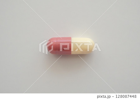 Brown medicine pill capsule on white background Brown medicine pill capsule on white background 128087448