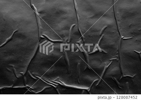 black crumpled and creased plastic poster texture background black crumpled and creased plastic poster texture background 128087452