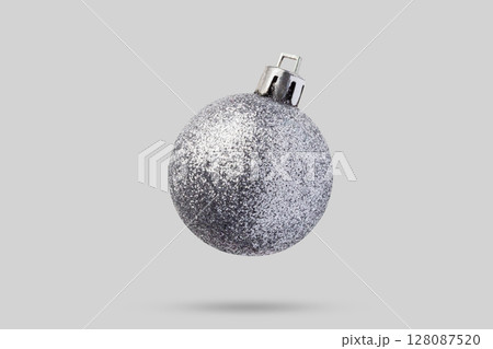 Silver Christmas ball isolated on gray background Silver Christmas ball isolated on gray background 128087520
