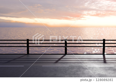 夕日がキラキラ海面に反射するガードレールがある海沿いの道 128089281