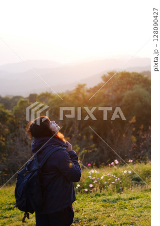 Asian young woman backpack smiling and standing with wildflower and beautiful landscape of valley Doi Luang Chiang Dao mountain, Chiang Mai Province of Thailand Asian young woman backpack smiling and standing with wildflower and beautiful landscape of valley Doi Luang Chiang Dao mountain, Chiang Mai Province of Thailand 128090427