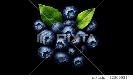 A cluster of ripe blueberries is displayed against a black background, emphasizing their rich blue hue and fresh green leaves 128090814