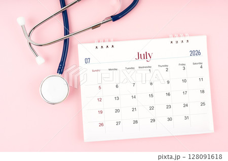 Blank July 2026 desk calendar and stethoscope, Medical appointment schedule to check up. 128091618