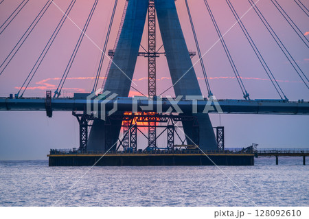 Sunset Through Danjiang Bridge Construction in Tamsui New Taipei City. Sunset Through Danjiang Bridge Construction in Tamsui New Taipei City. 128092610