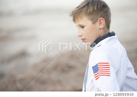 Handsome boy wearing clothes with American flag print. Handsome boy wearing clothes with American flag print. 128093910