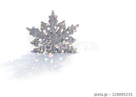 Silver snowflake on white snow. Silver snowflake on white snow. 128095235