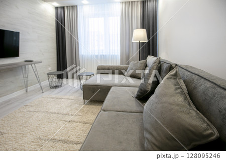 Part of the room with a sofa in beige tones. 128095246