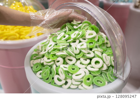 Jelly candies in containers in a store. Large selection of sweets in different colors. Sale of sweets. Jelly candies in containers in a store. Large selection of sweets in different colors. Sale of sweets. 128095247