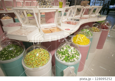 Jelly candies in containers in a store. Large selection of sweets in different colors. Sale of sweets. Jelly candies in containers in a store. Large selection of sweets in different colors. Sale of sweets. 128095252