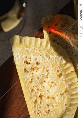 Qutab flatbreads on board with glass of red wine Qutab flatbreads on board with glass of red wine 128096119