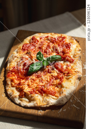 Pinsa margherita with tomato, cheese and basil Pinsa margherita with tomato, cheese and basil 128096124