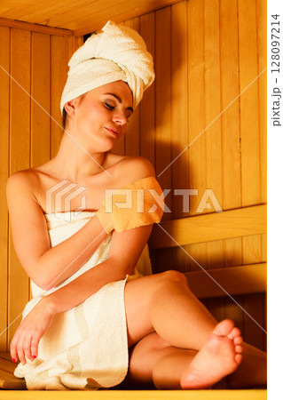 woman relaxing in wooden sauna room 128097214