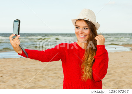 Happy woman with phone taking selfie photo. 128097267