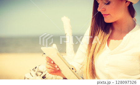 Girl with tablet on seaside. Girl with tablet on seaside. 128097326