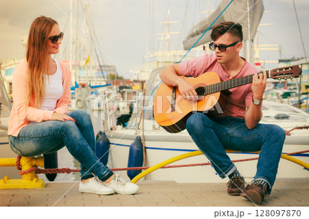 Happy couple with guitar outdoor Happy couple with guitar outdoor 128097870