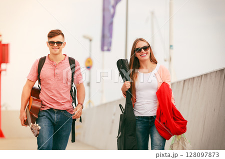 Happy couple with guitar outdoor Happy couple with guitar outdoor 128097873