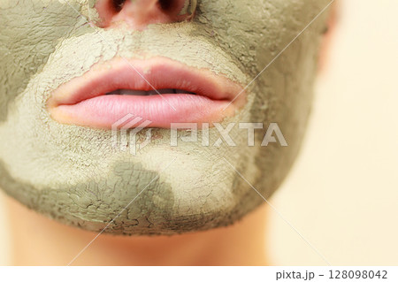 Woman face with green clay mud mask Woman face with green clay mud mask 128098042