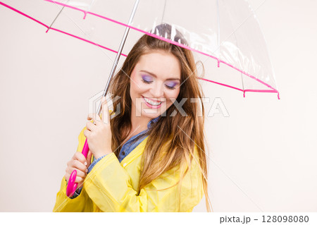 Woman wearing waterproof coat under umbrella Woman wearing waterproof coat under umbrella 128098080