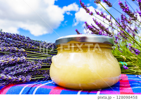 Jar with honey and lavender flowers. 128098458