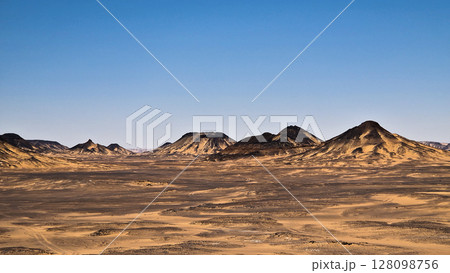 Ash-covered hills in Egypt's Black Desert under a clear sky, scenic and remote landscape. Volcanic	 128098756