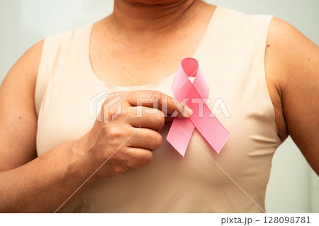 Asian woman with pink ribbon for October world breast cancer day. Asian woman with pink ribbon for October world breast cancer day. 128098781