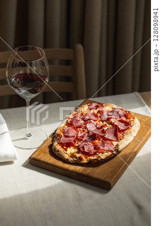 Pinsa with cured meat and cheese 128098941