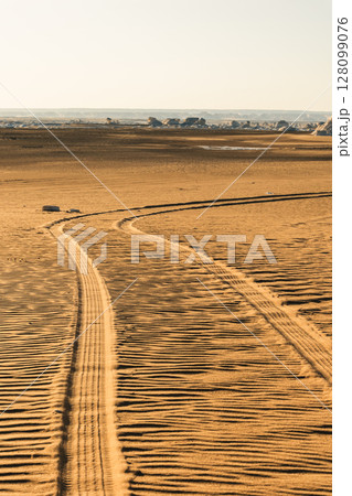 Tire mark on the sand after the car. Texture after car's wheel 128099076