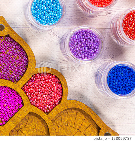 Colorful glass beads. Variety of shapes and colors to make a bead necklace or a string of beads for women 128099757