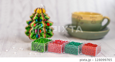 Colorful glass beads with christmas tree. Variety of shapes and colors to make a bead necklace or a string of beads for women Colorful glass beads with christmas tree. Variety of shapes and colors to make a bead necklace or a string of beads for women 128099765