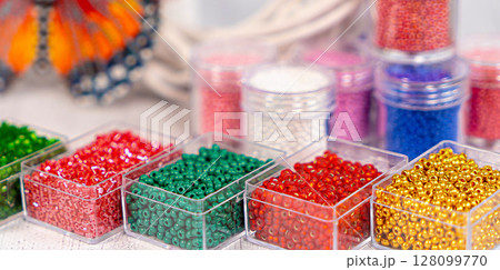 Colorful glass beads. Variety of shapes and colors to make a bead necklace or a string of beads for women 128099770